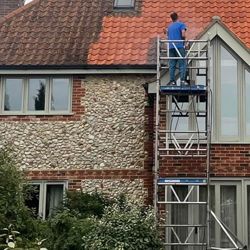 Aldous Cleaniing Services operate from a scaffolding tower to steam wash or soft was roofs